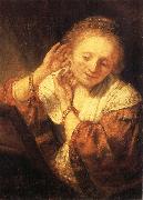 REMBRANDT Harmenszoon van Rijn Young Woman Trying on Earrings Spain oil painting artist